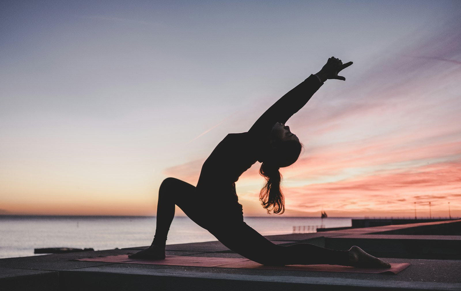 Woman in her mid 50s practicing yoga outdoors